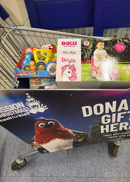 Shopping cart with toys for donation